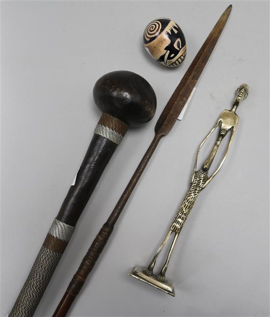 A Knobkerrie, a spear, a figure and a stone